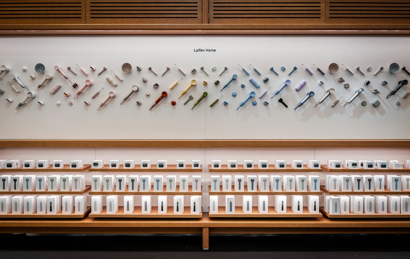 Kitchen utensils and packaged products arranged on wooden store shelves.