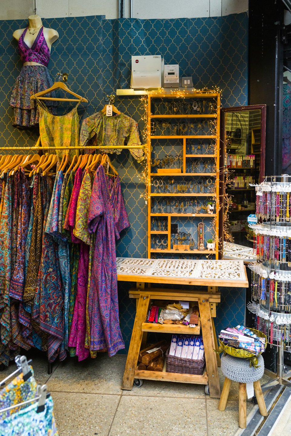 Colorful clothing and jewelry displayed in a boutique shop.